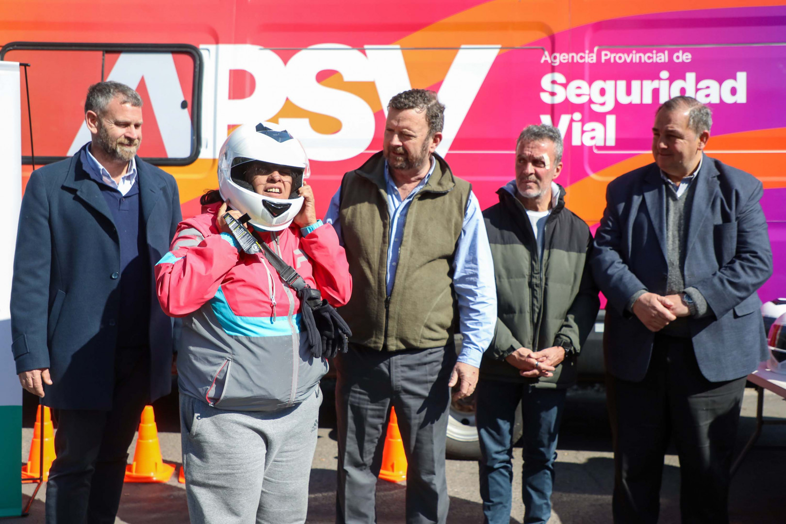 Funcionarios representantes de la APSV y la ANSV observan a una conductora de motos que se prueba un casco homologado en la Clínica de Conducción Segura de Motos realizada en la provincia de Santa Fe.