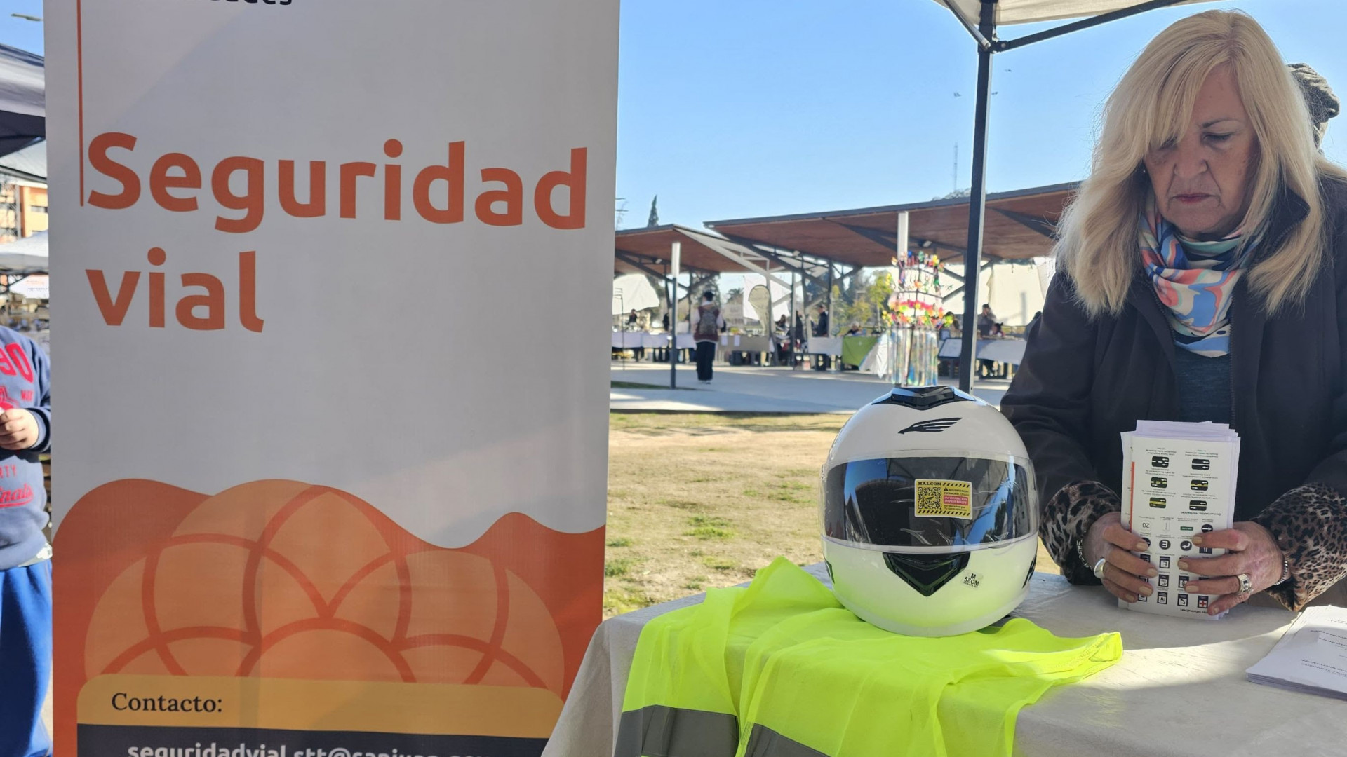 Una mujer ordena folletería en el Stand de Seguridad Vial en la Feria Agroproductiva que realiza el Ministerio de Producción de San Juan